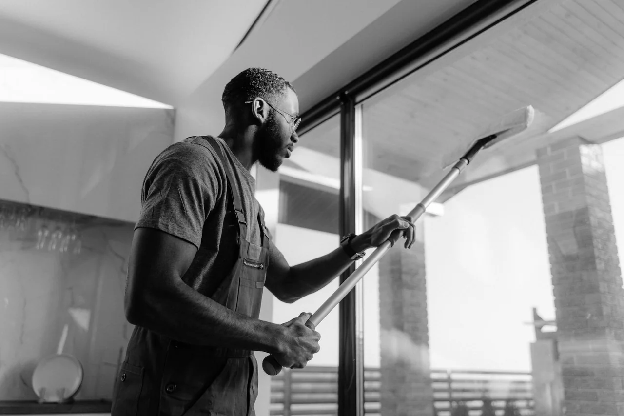 Professional cleaner working on glass panels