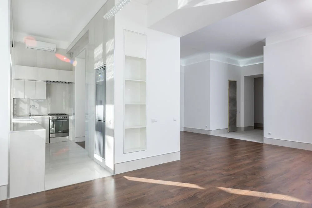 Spacious clean living room with wooden floors